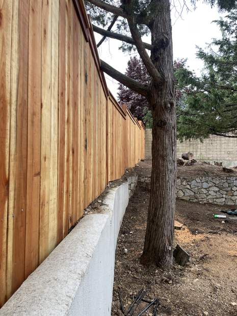 Cedar privacy fence along slope